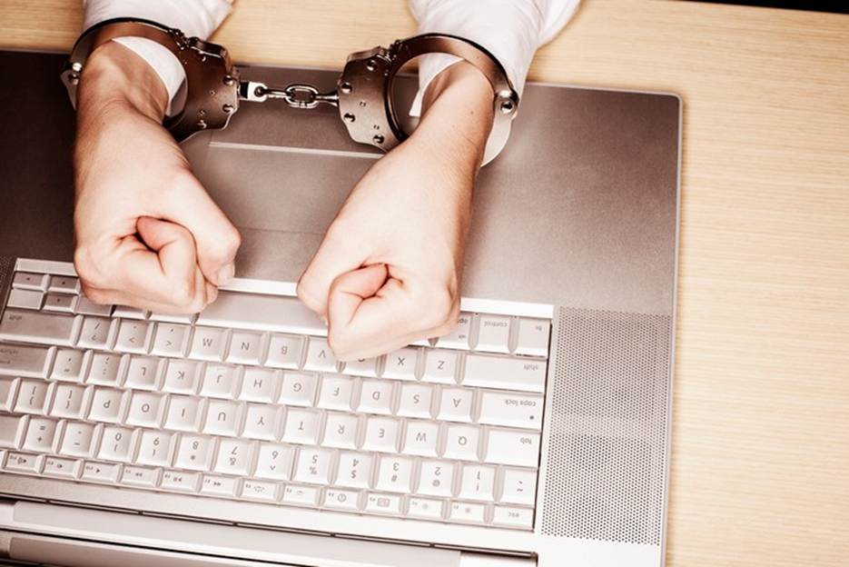 Hands handcuffed over a laptop represent being bound by technology. In the context of the website content, this imagery highlights the potential restrictions or controls within the platform's editing environment.